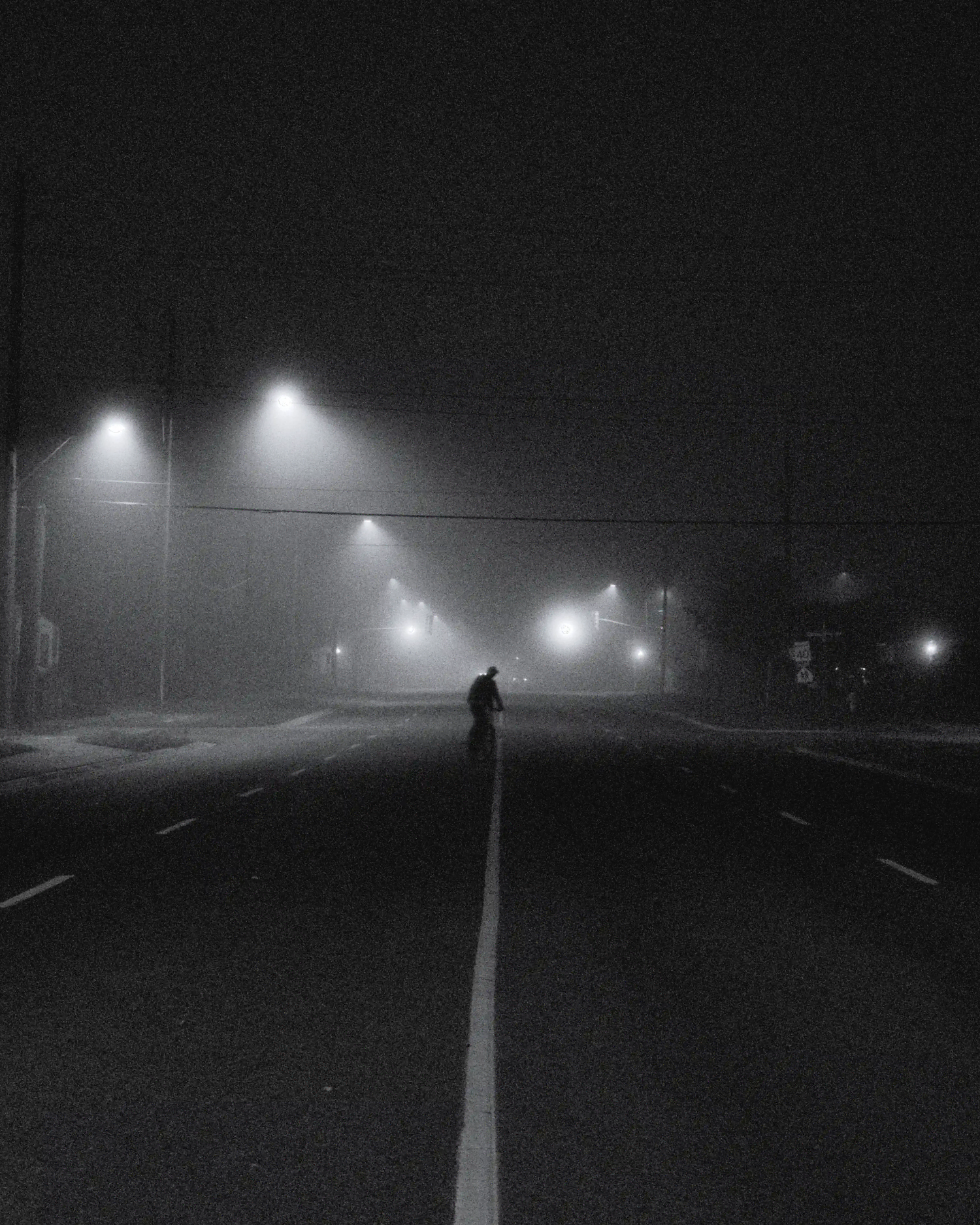 man on cycle on foggy night thunderbay