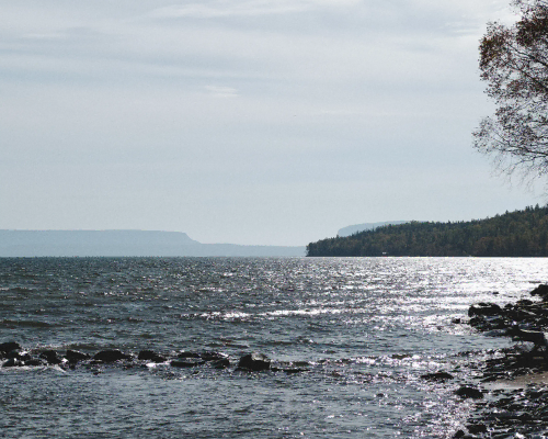 sandy beach with mountain in horizon thunderbay